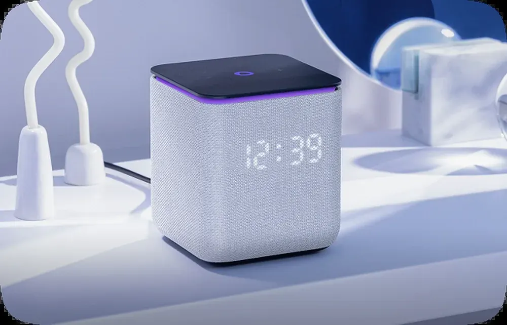Smart speaker with clock display on a desk, relevant to comparing smart speaker options in the UAE